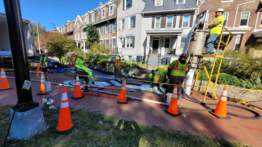 Workers at a site in a city street