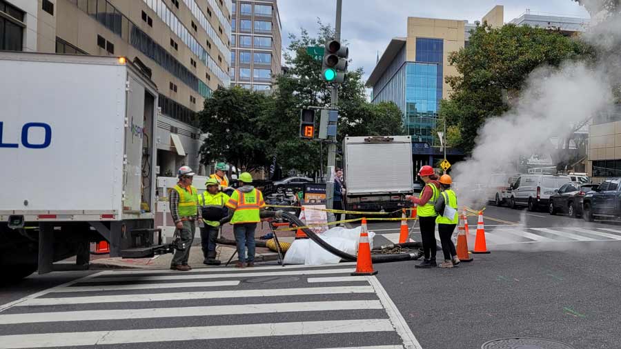 Even more workers at a site in a city street